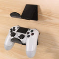 A universal plastic wall mount bracket for game controllers, shown in black colour