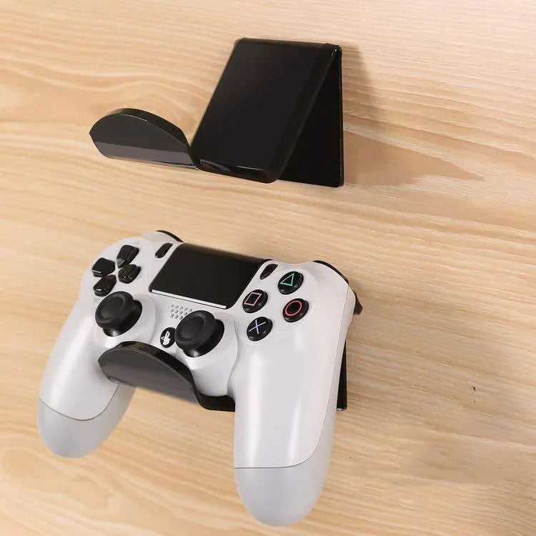 A universal plastic wall mount bracket for game controllers, shown in black colour