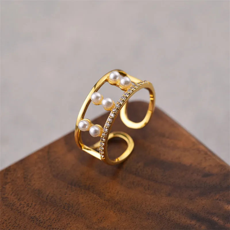 Korean fashion women's open geometric ring in electroplated gold colour on a plain background.