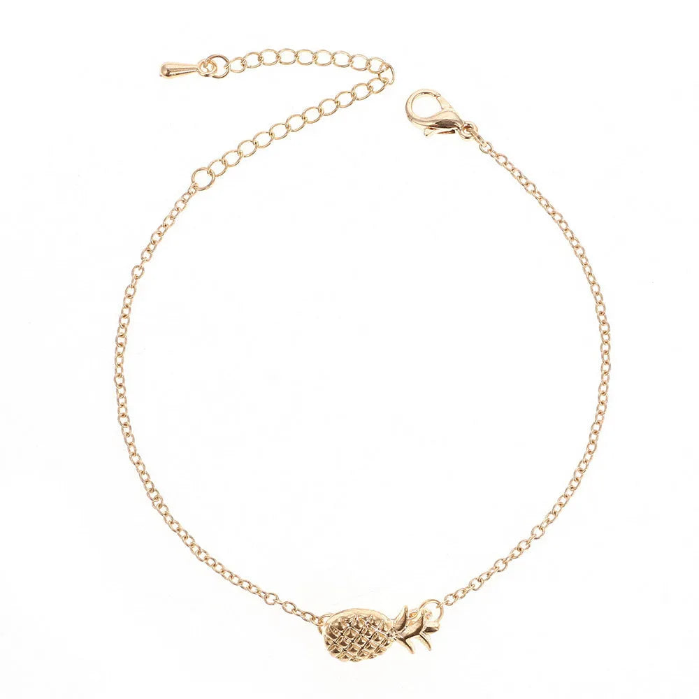 Close-up of a women's alloy bracelet with a small pineapple charm in gold or silver.