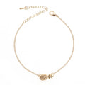 Close-up of a women's alloy bracelet with a small pineapple charm in gold or silver.
