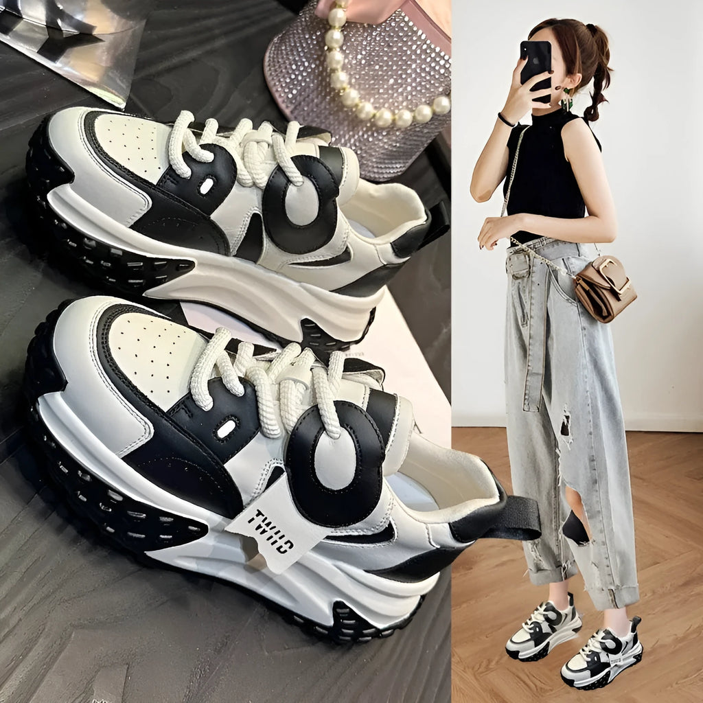 Women's leather sports casual shoes with thick sole and lace-up front in black and white colour.