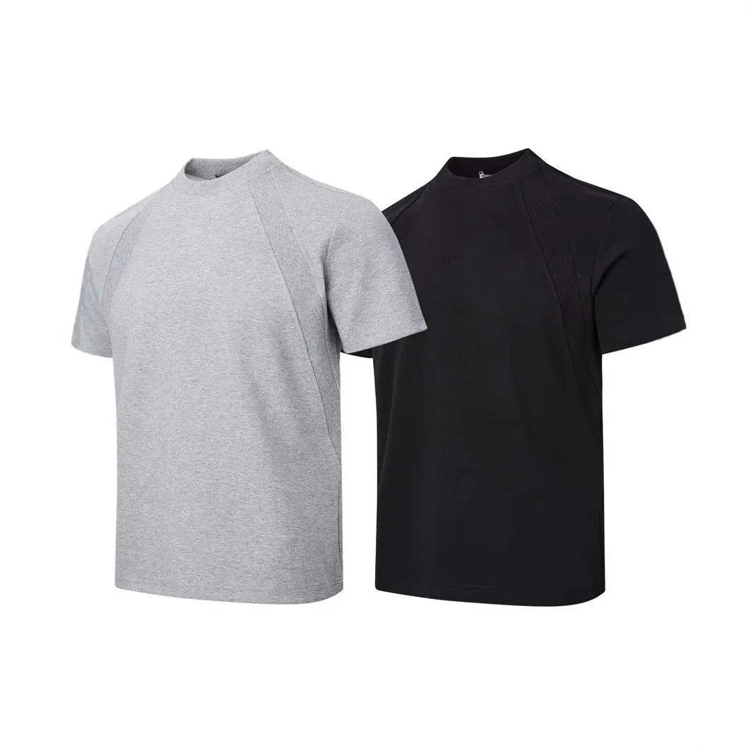 Man wearing a loose fit grey short sleeve top with visible air layer stitching texture.
