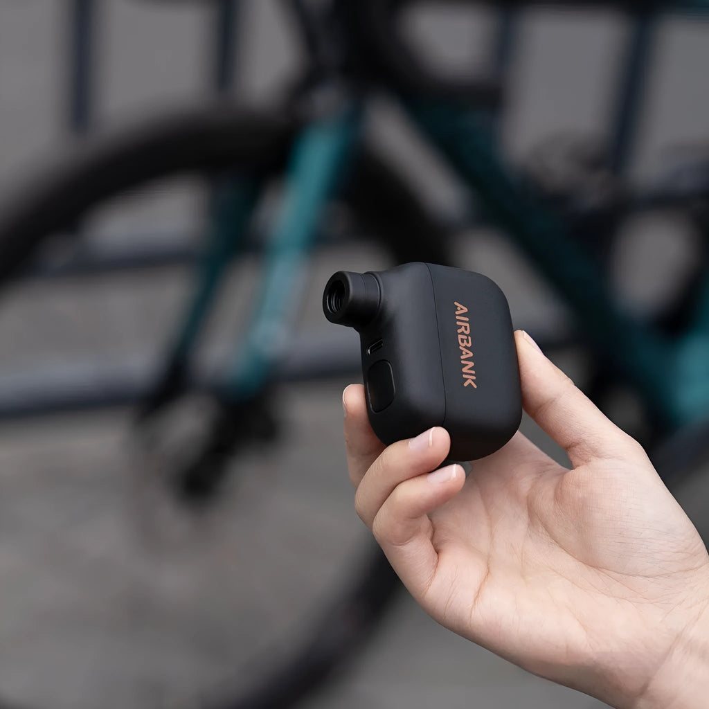 Black AS100 electric bike pump with USB cable and waterproof bag