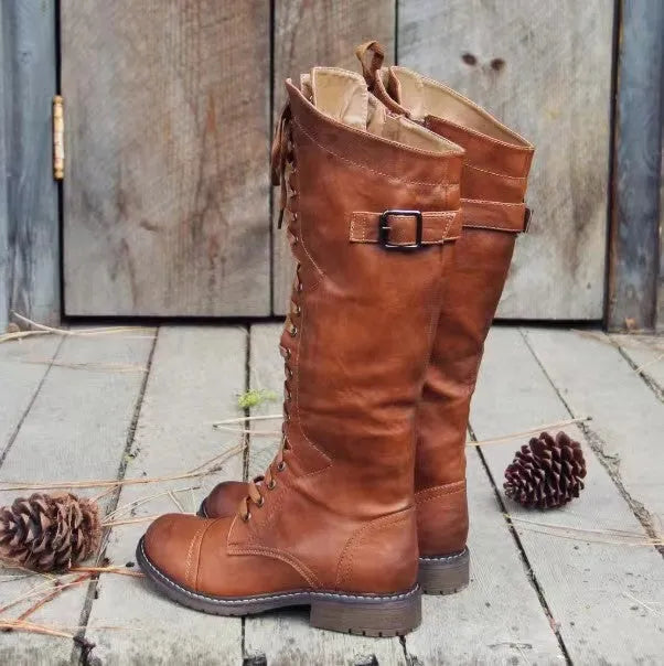 Women's black high leg boots with a chunky low heel and round toe on a plain background.