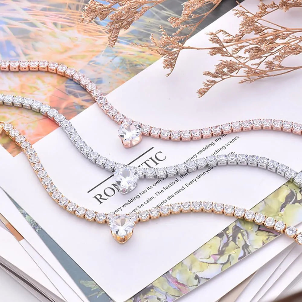 Gold metallic pet collar with a heart-shaped rhinestone design and an extension chain.