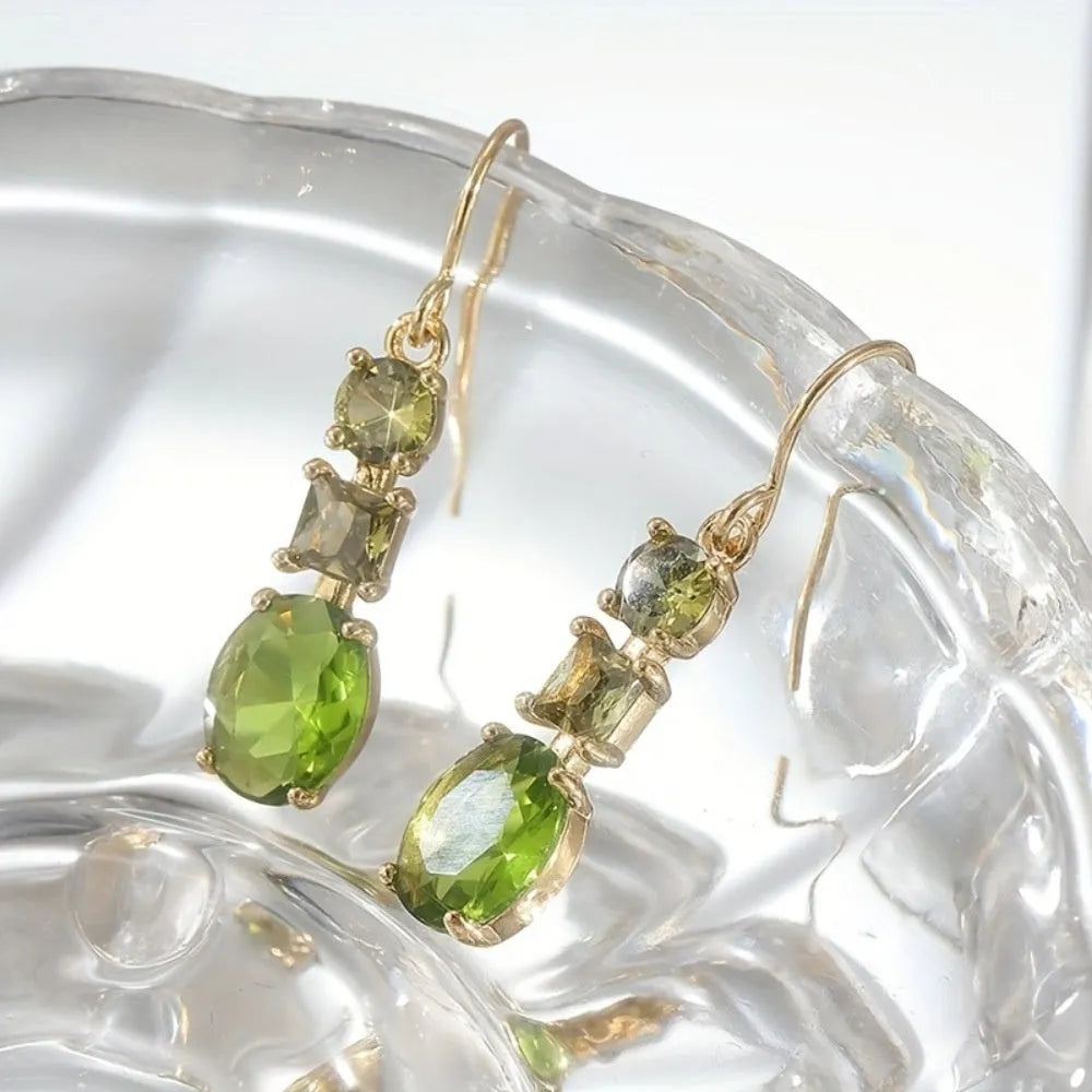 A pair of green geometric quadrilateral earrings made from copper, showing a simple retro bohemian style.