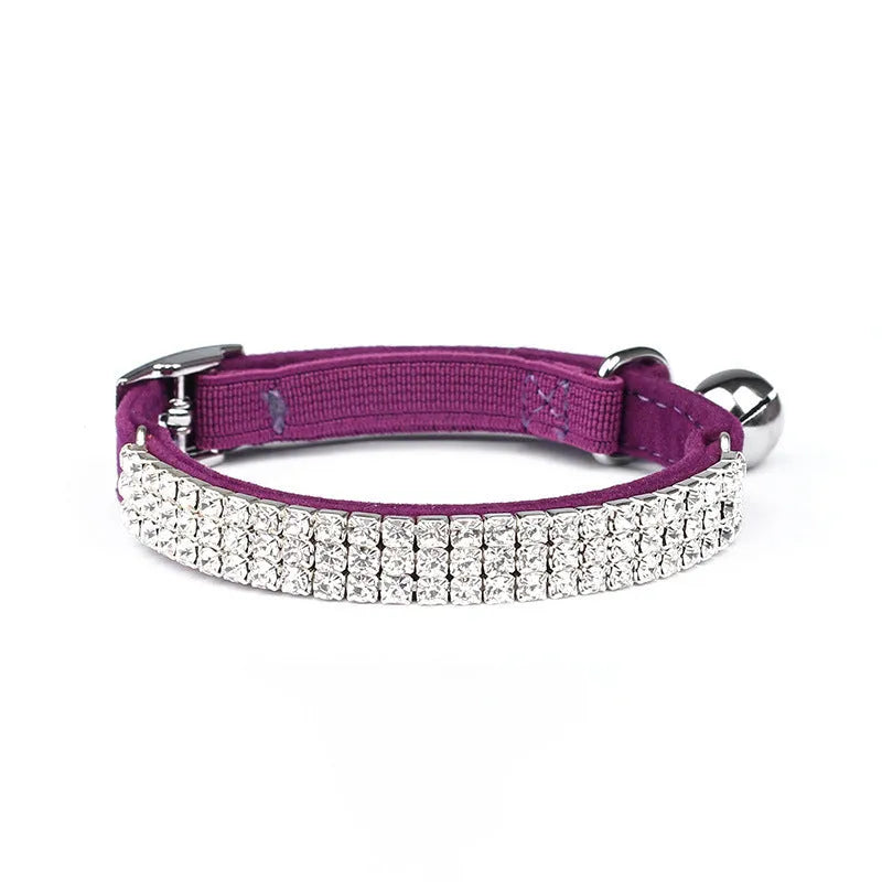 A soft red velvet cat collar with rhinestone decoration, showing the adjustable buckle.