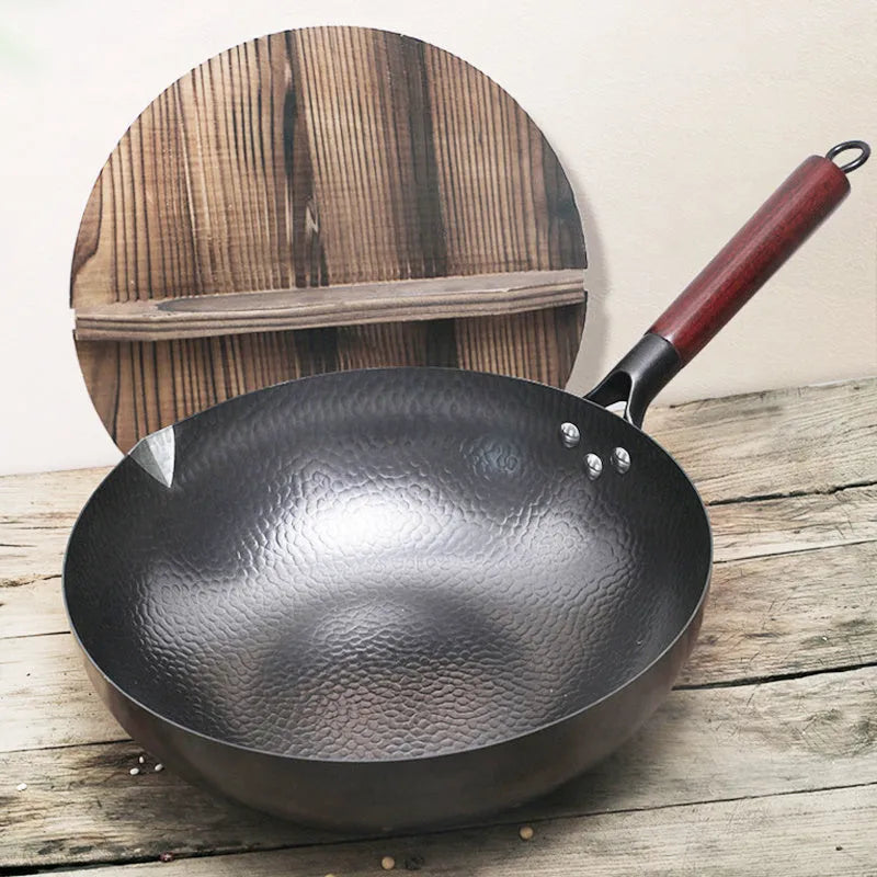 Traditional black iron wok pan with wooden handle measuring 32cm diameter