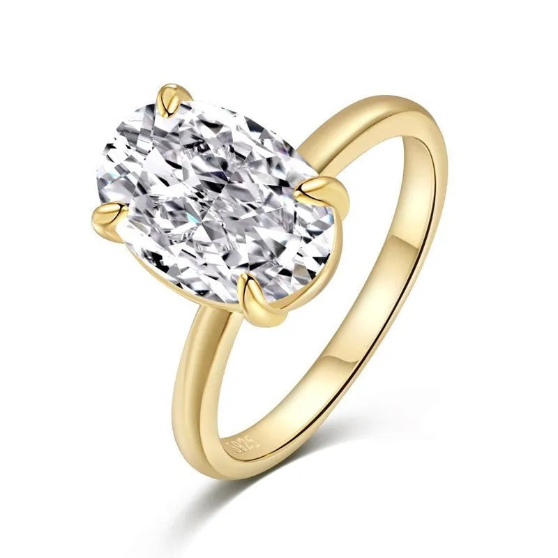 Oval ring with four-claw setting showing hand-cut gemstone in gold and silver colour options