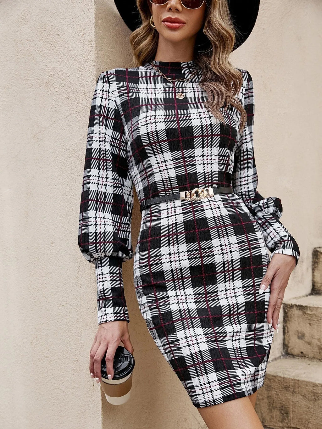Black tight dress with lantern sleeves and leather stitching detail, mid-length design