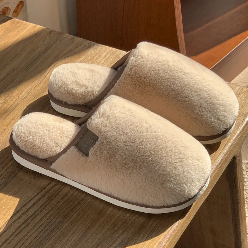 Winter plush slippers in blue colour with non-slip PVC soles, showing car stitching detail