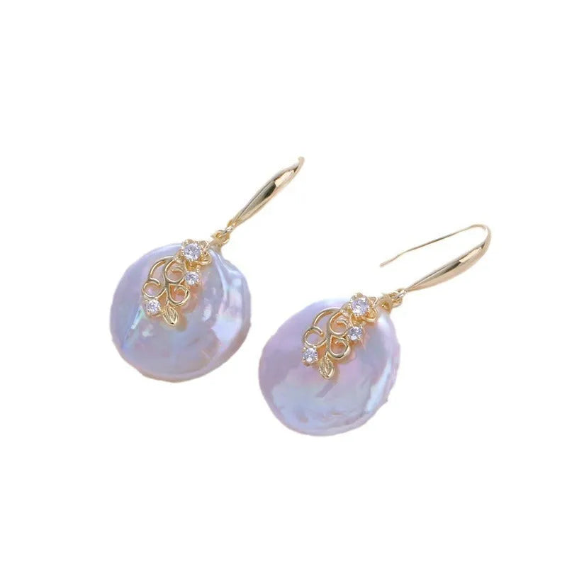 Women's baroque shaped pearl ornament necklace and earrings set with geometric O-ring chain on display