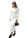 A woman wearing a black French retro slim fit knitted long sleeve dress with button detail.