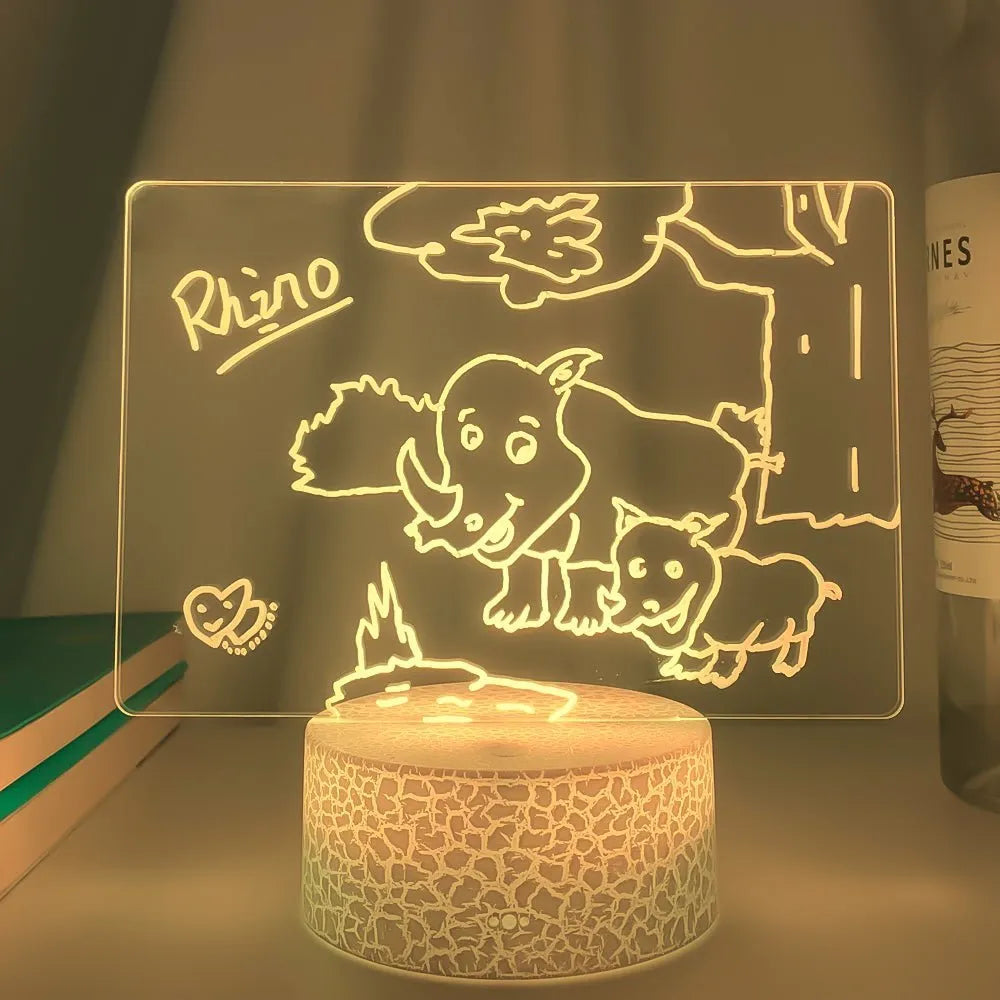 3D acrylic LED message board night light on a desk, showing illuminated surface and remote control
