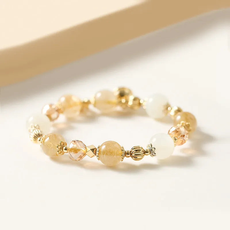 Gold coloured rutilated quartz bracelet with Korean style design on wrist
