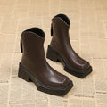 Black platform Martin boots for women with a square toe, back zipper, and a high heel.