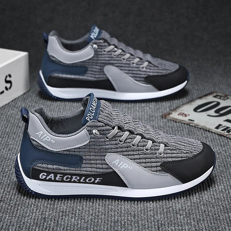 Men's grey and green mesh low-top lace-up running shoes on a white background.