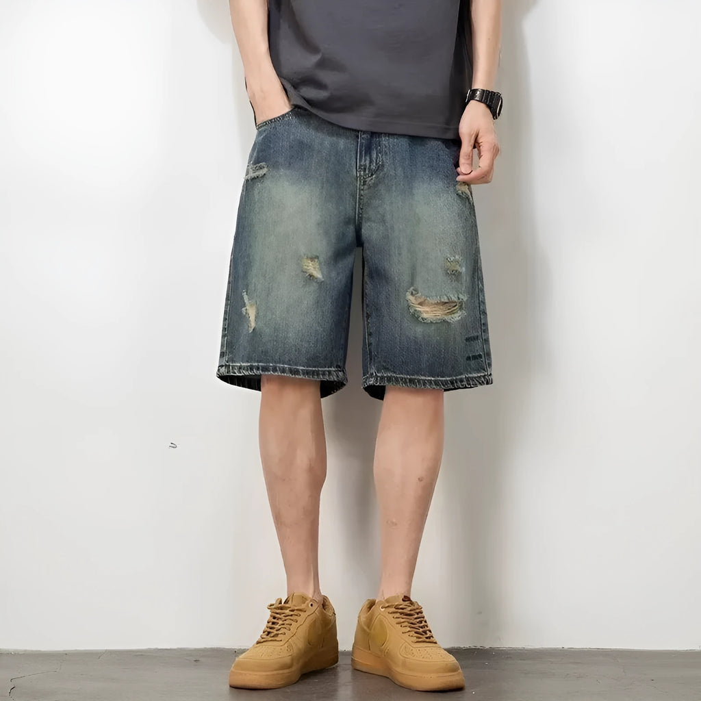 Men's blue retro loose hole denim shorts with a straight leg cut on a neutral background.