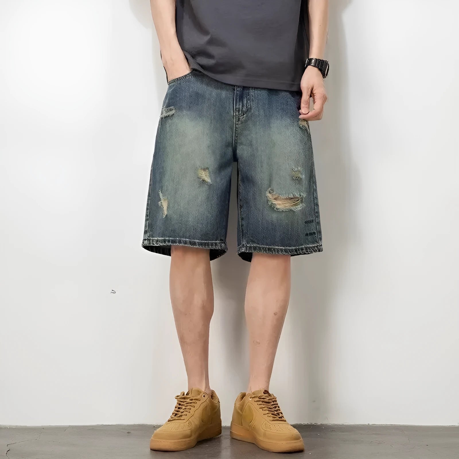 Men's blue retro loose hole denim shorts with a straight leg cut on a neutral background.