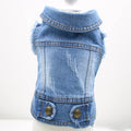 Small dog wearing a denim vest with a retro scratch pattern in a light wash colour.