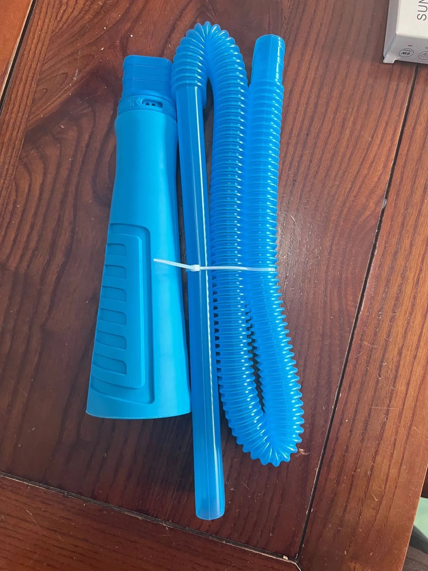 Blue plastic suction pipe cleaning tool with round head, 114cm length for appliance maintenance