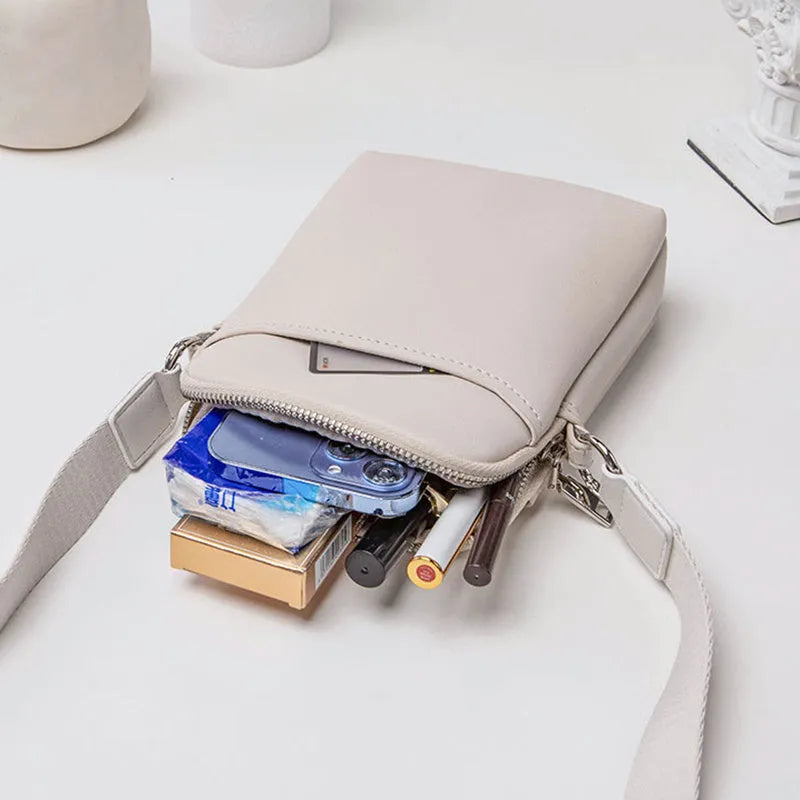Women's solid colour PU crossbody shoulder bag showing compact dimensions and adjustable strap