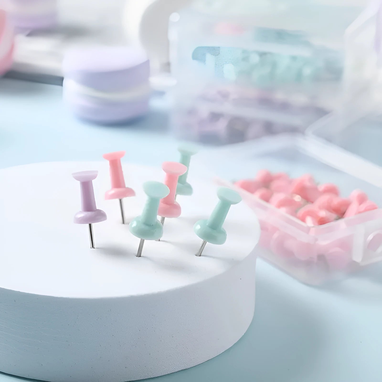 Boxed set of macaron-coloured plastic push pins in cherry blossom pink, mint green, and lavender, showing large and small sizes.