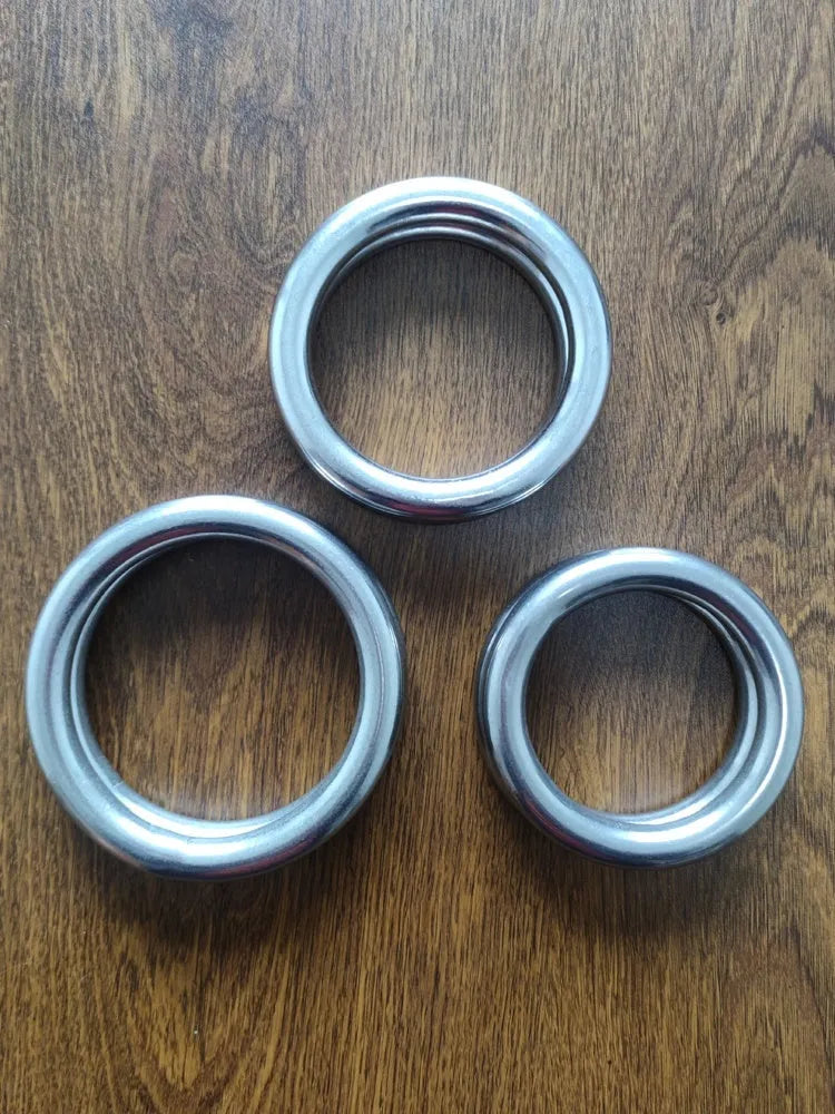 Carbon steel Wing Chun training ring for Iron Arm Skill on a plain background, showing three size options.