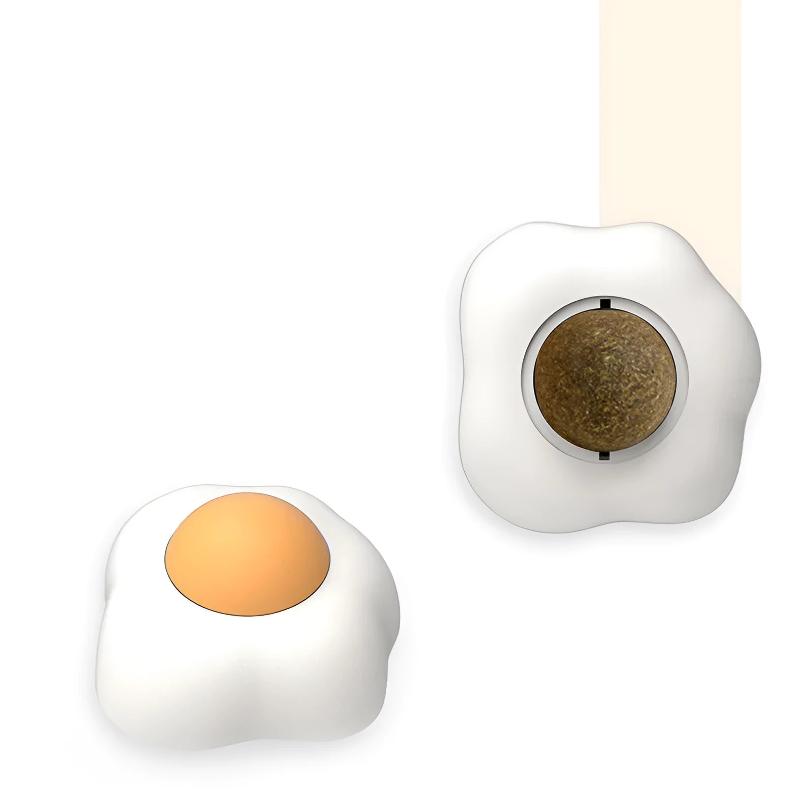 Soft plush catnip ball toy with adhesive base sticking to a wall for interactive feline play