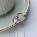 Adjustable open-mouth vintage ring in antiqued copper with a white chalcedony-style colour.