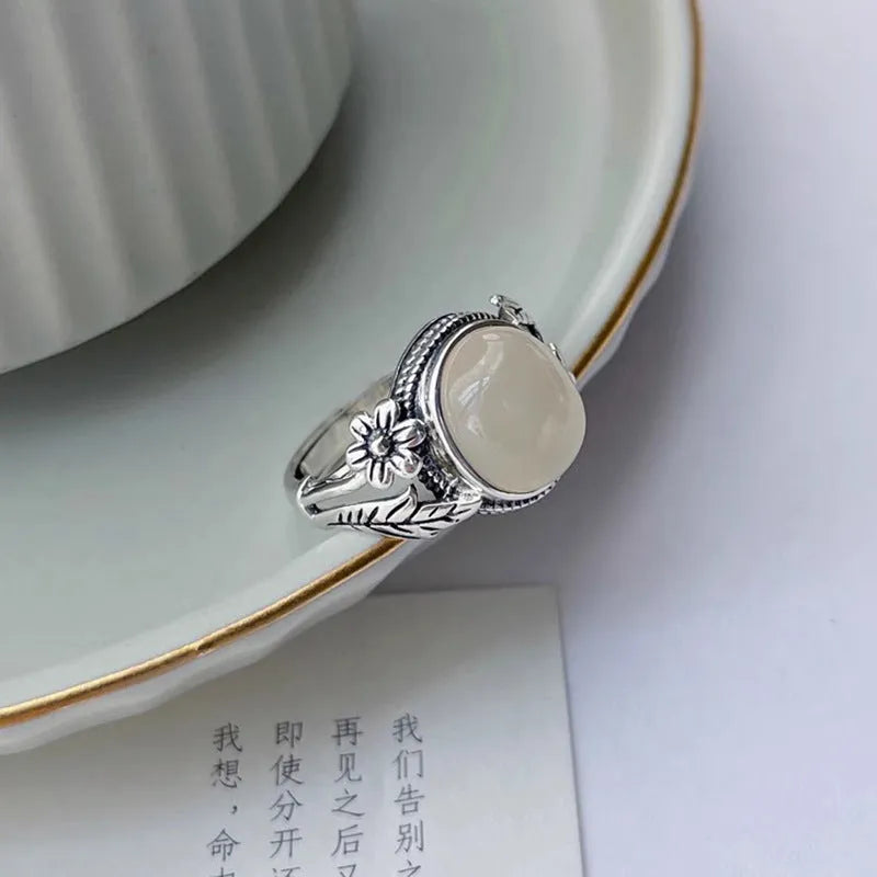 Adjustable open-mouth vintage ring in antiqued copper with a white chalcedony-style colour.