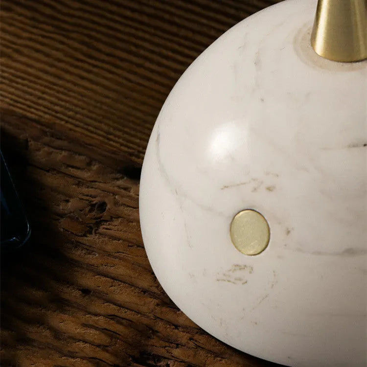 Modern desk lamp with a glass lampshade and touch-sensitive base for dimming control.