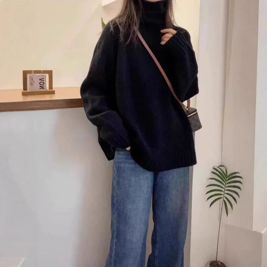 Women's loose black turtleneck sweater with a thick curling pile collar, casual style.
