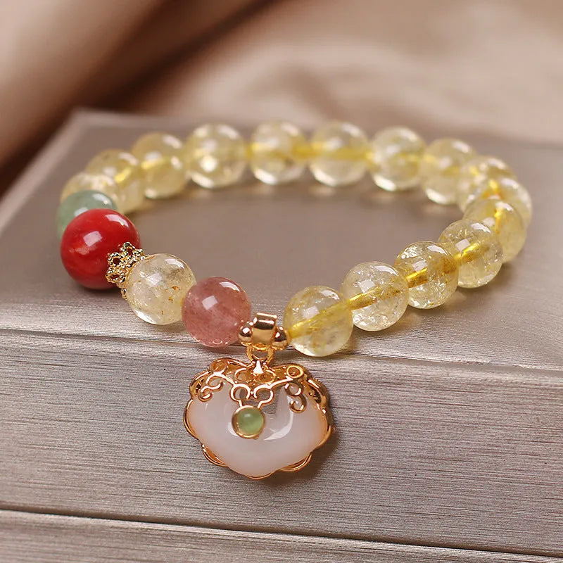 Women's bracelet with a yellow citrine jade ruyi pendant on an alloy chain.