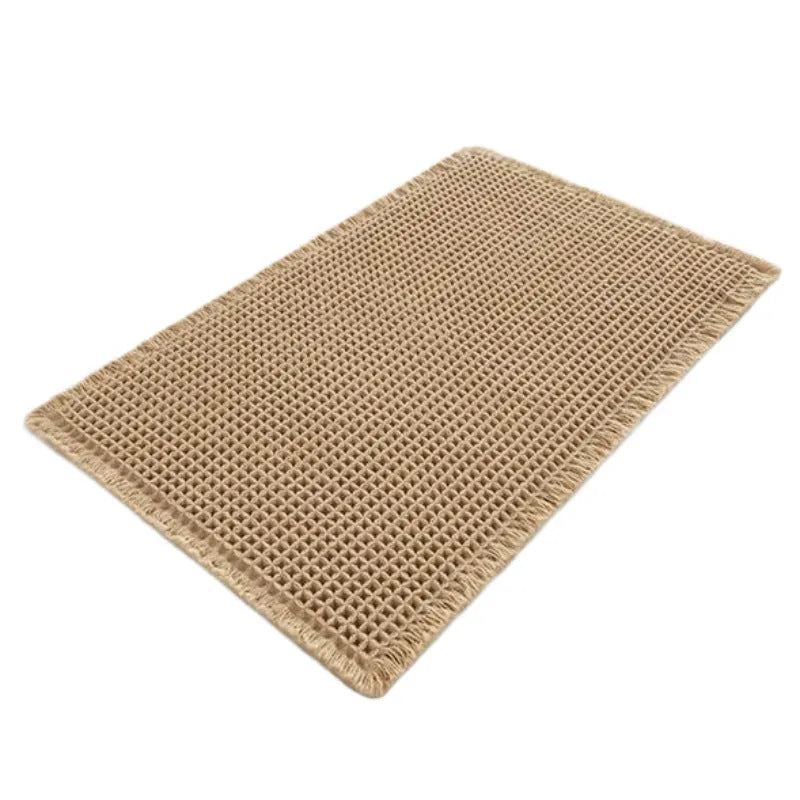 Beige and white checkered woven polyester bathroom floor mat on tiles.