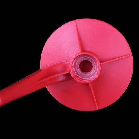 Red plastic Magic Tap soda bottle dispenser attached to an inverted 2-litre bottle.