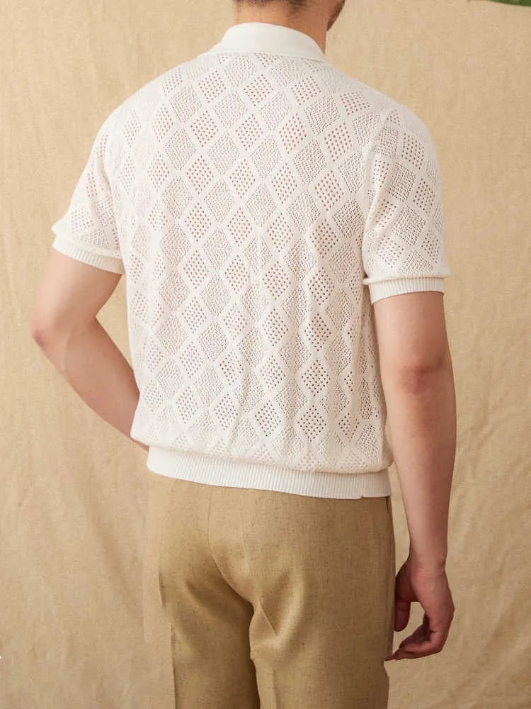 White cotton zip-front cardigan with lapel collar and short sleeves laid flat.