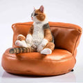 Small lazy cat figurine with sofa car ornament on a dashboard