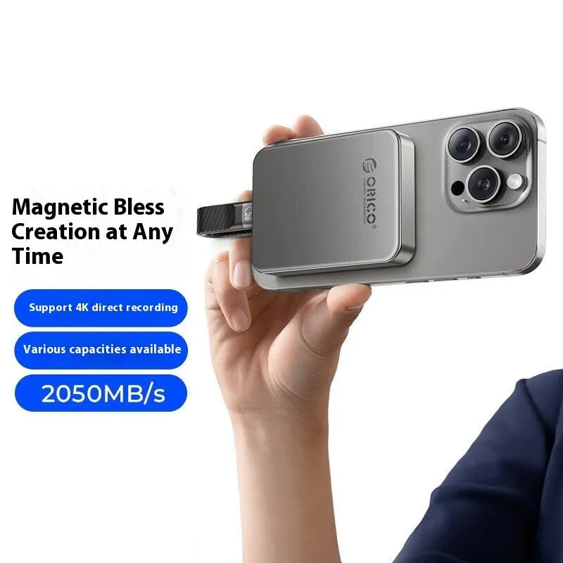 Grey magnetic mobile solid state drive with C to C cable on a desk