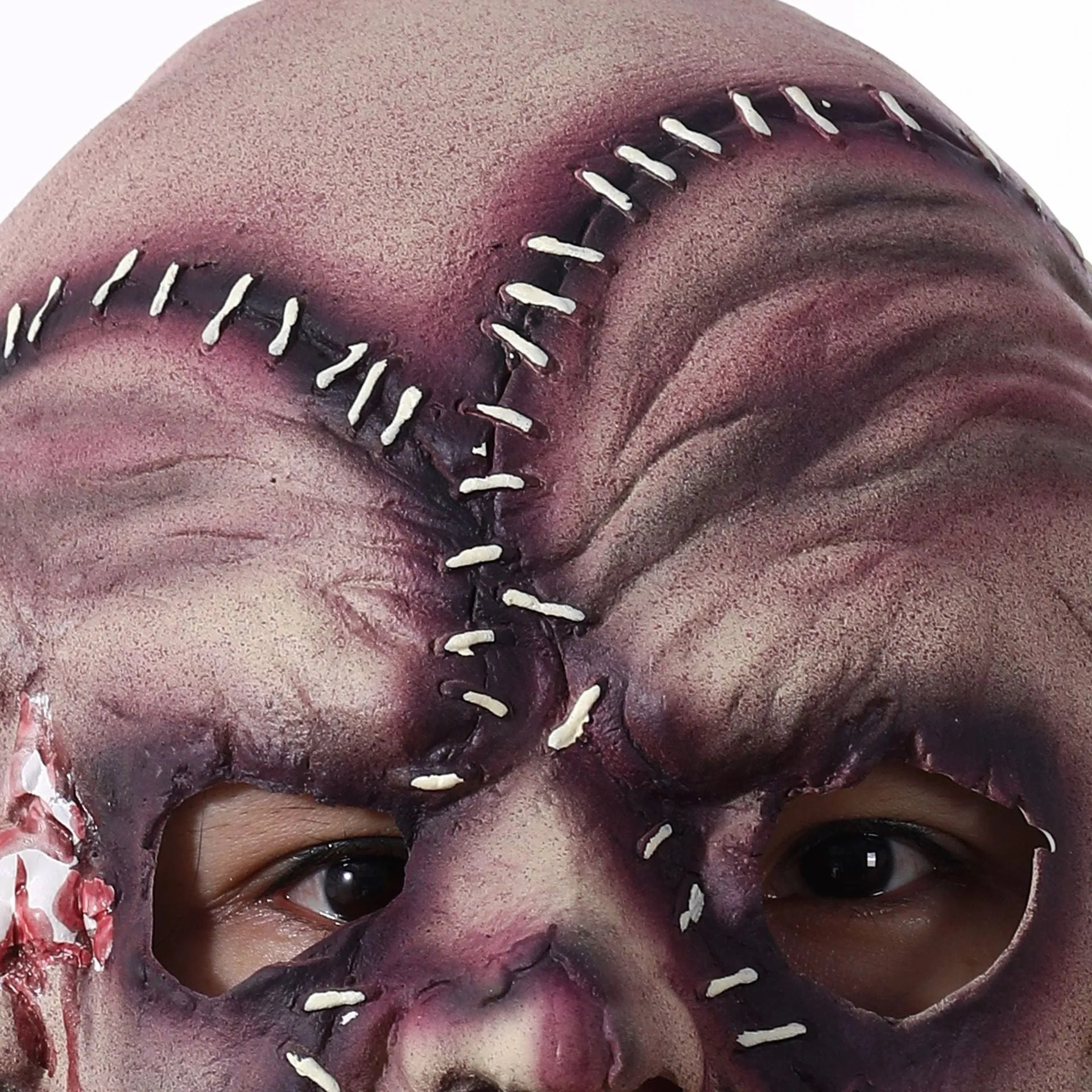 Three-sided grimace horror Halloween mask showing detailed latex texture and facial expression