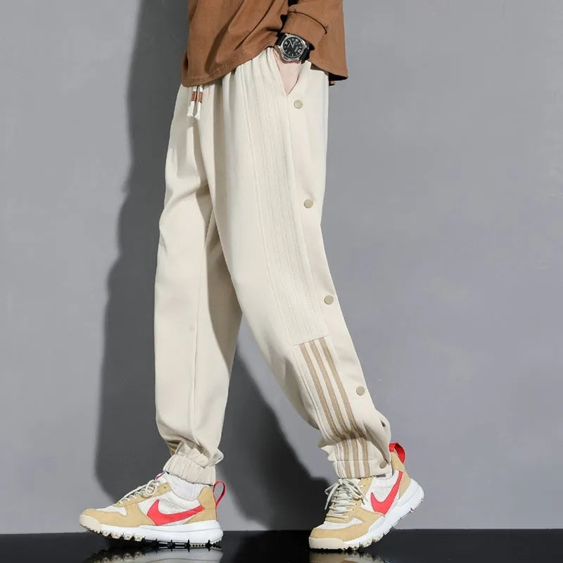 Men's black loose-fit cotton blend sweatpants with ankle ties and a drawstring waist.