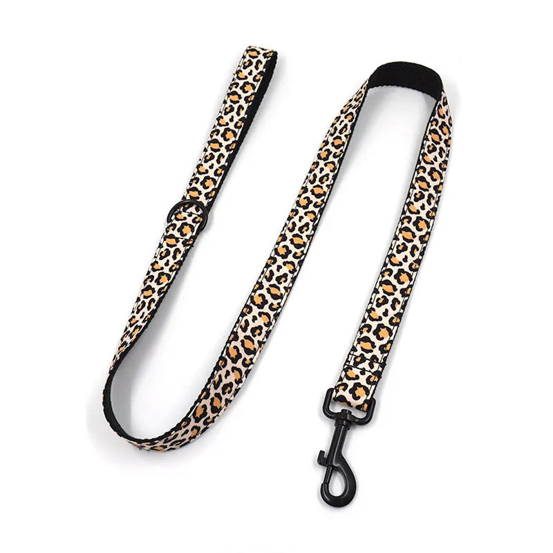 Brown leopard print dog collar and leash set with black buckle on a green background