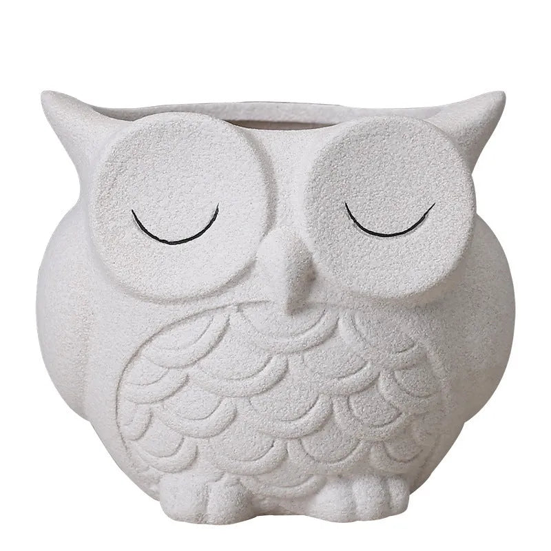 Handmade frosted ceramic succulent pot with cartoon owl design, shown in light pink.