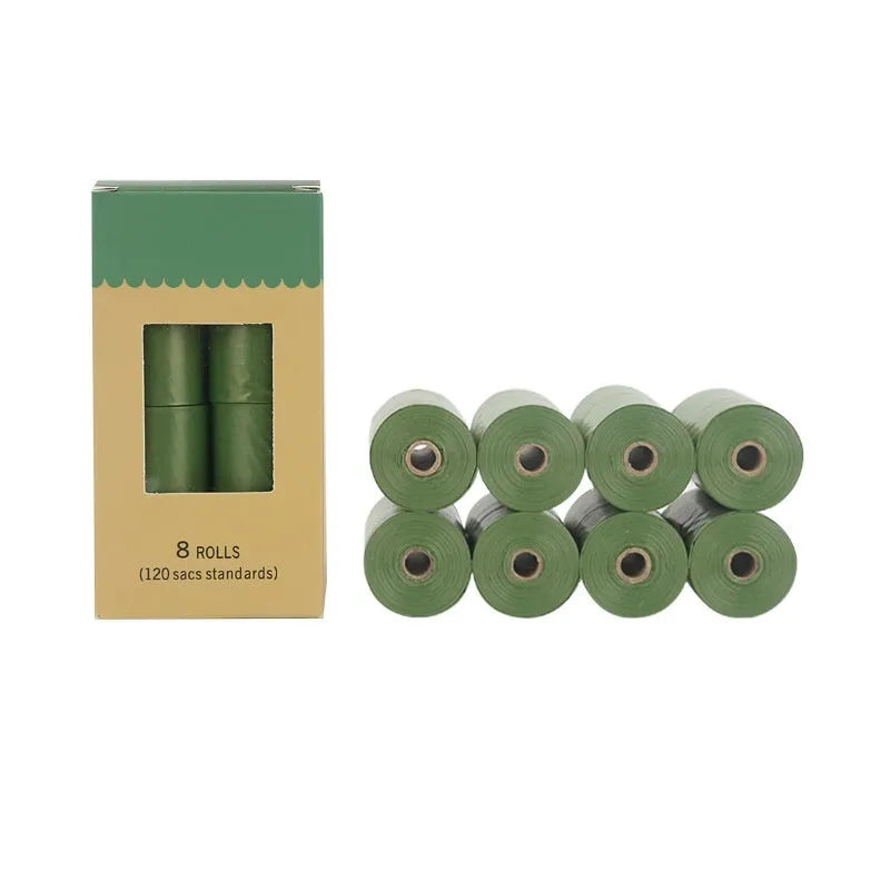 Roll of EPI degradable green dog poo bags next to a black portable dispenser on a green background.