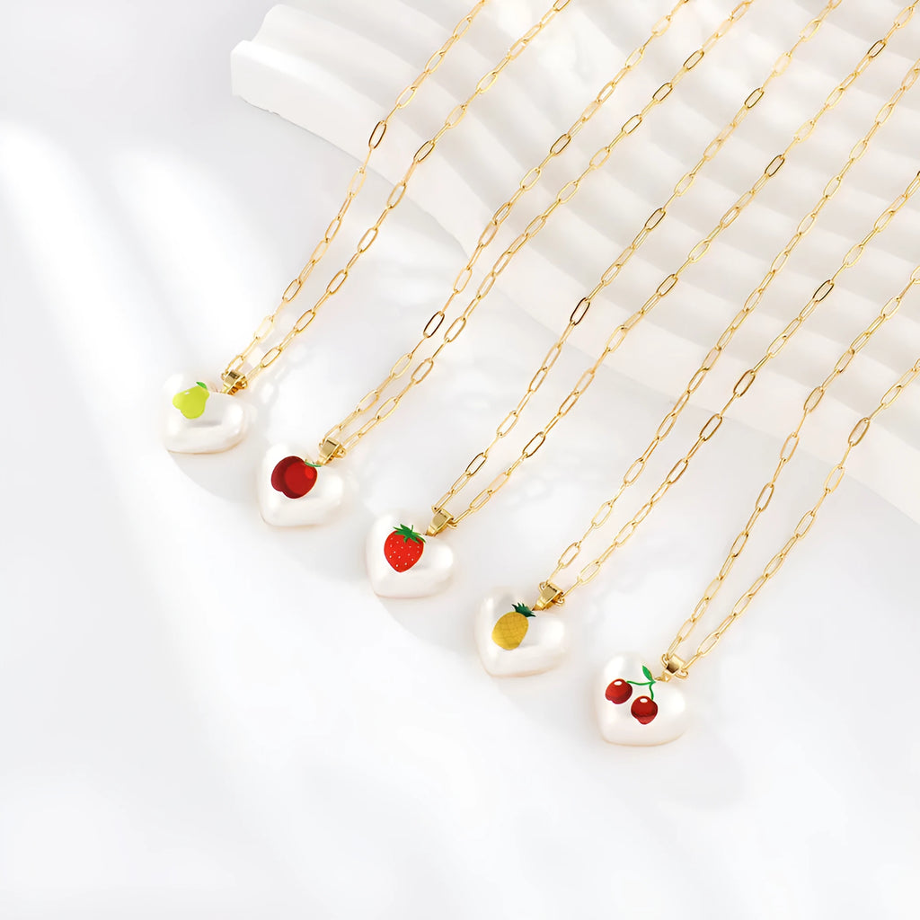 Adjustable chain necklace with a choice of geometric fruit pendant charms: apple, cherry, pear, pineapple, or strawberry.