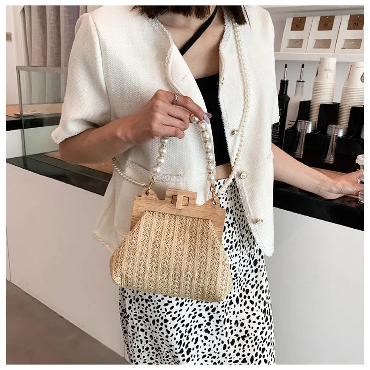 Women's straw woven shoulder bag with pearl chain detail in horizontal square shape