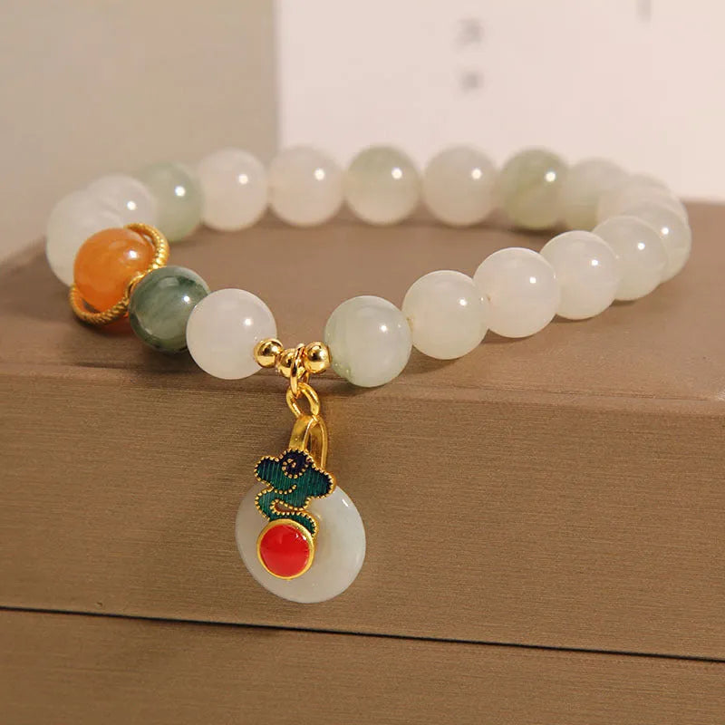 Women's ice jade bracelet with pearl accents and xiangyun peace jade buckle in retro design
