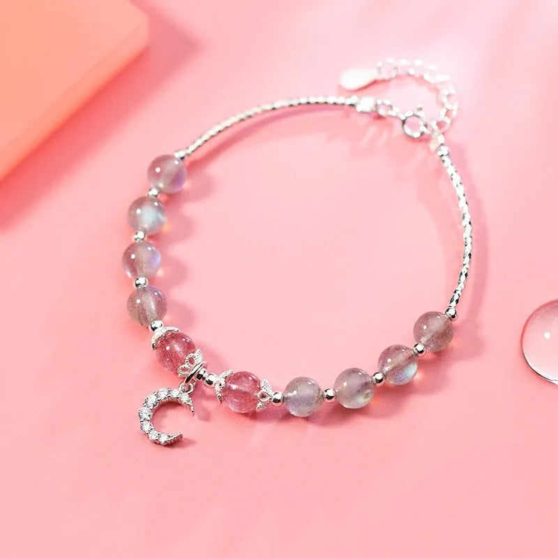 Handmade silver-tone adjustable bracelet with a moonstone bead and crescent moon charm.