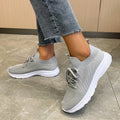 Women's mesh running shoes in creamy white with Flyknit upper and rubber sole